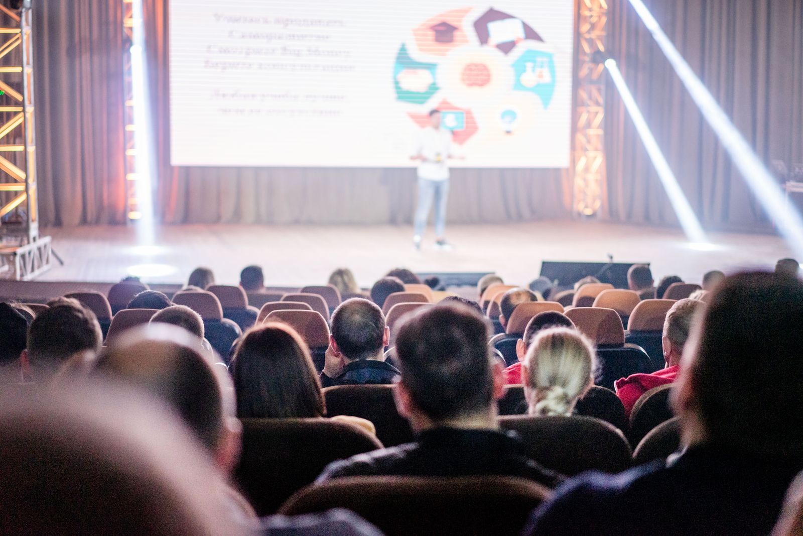 Conference audience watching an oncology research presentation